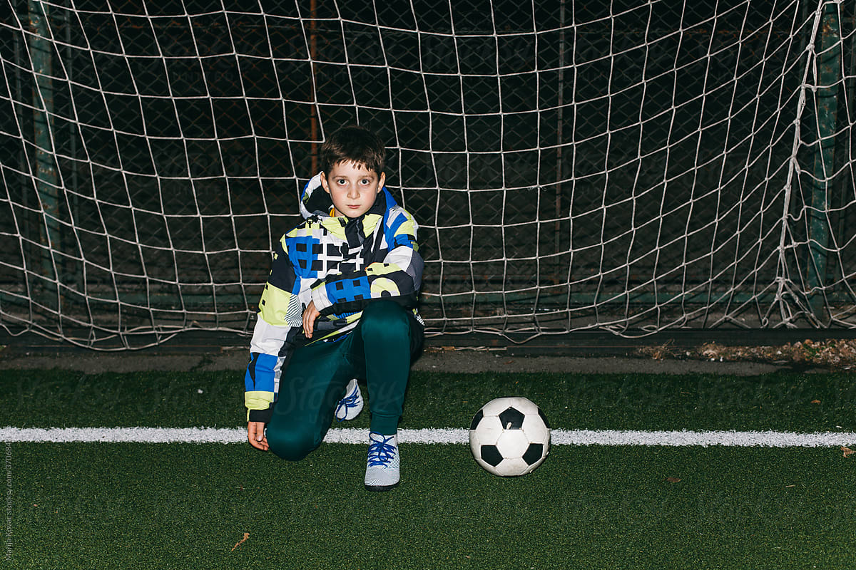 Kid posing with his football ball