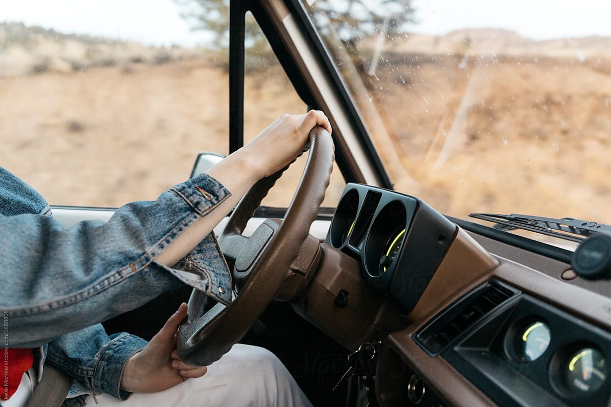 Young female drives vintage truck in wilderness environment