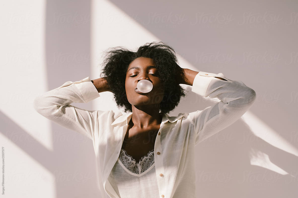 Black woman blowing bubble from gum