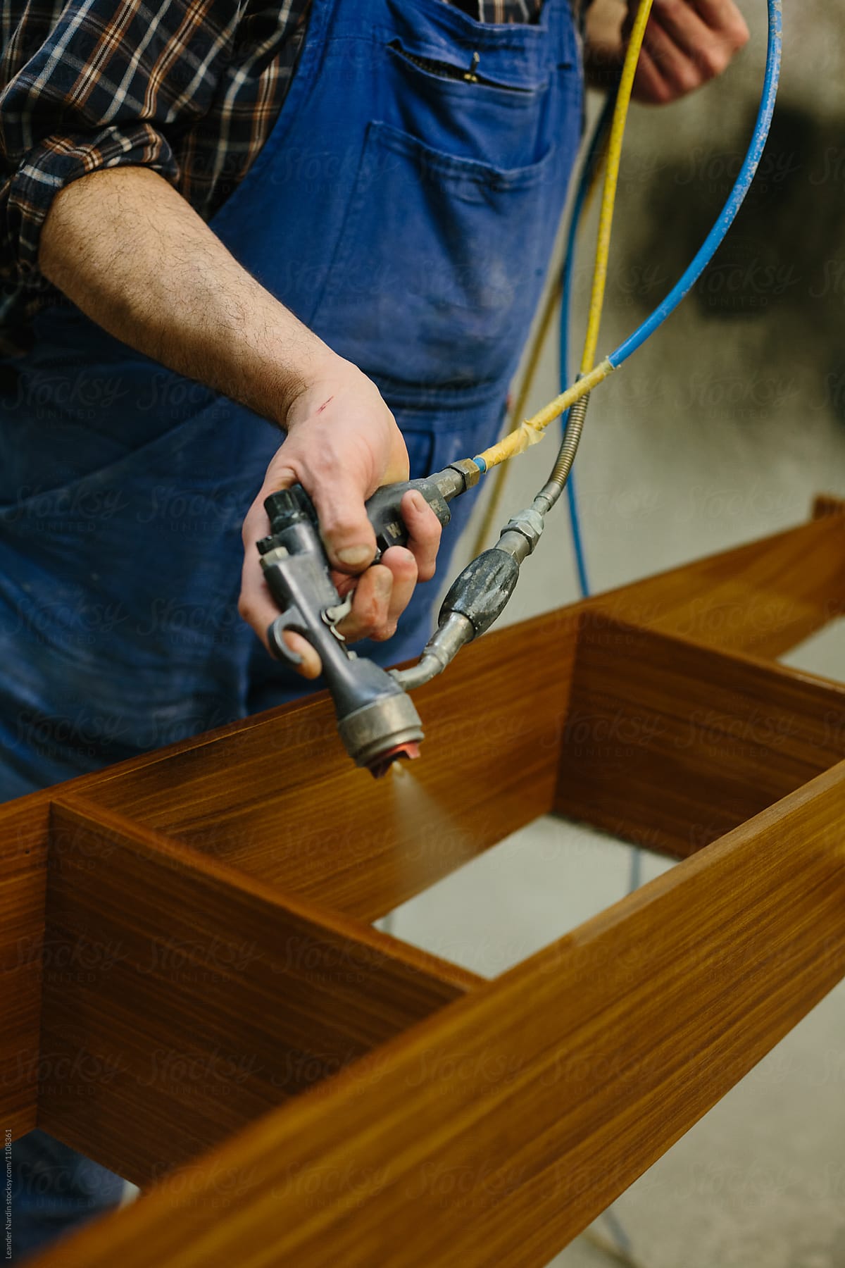 boat builder varnishing wooden furniture