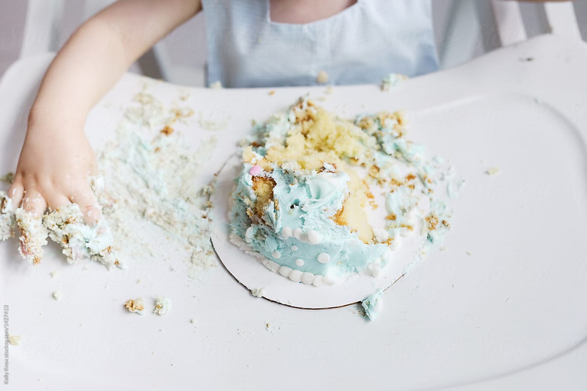 baby has made a mess of his first birthday cake
