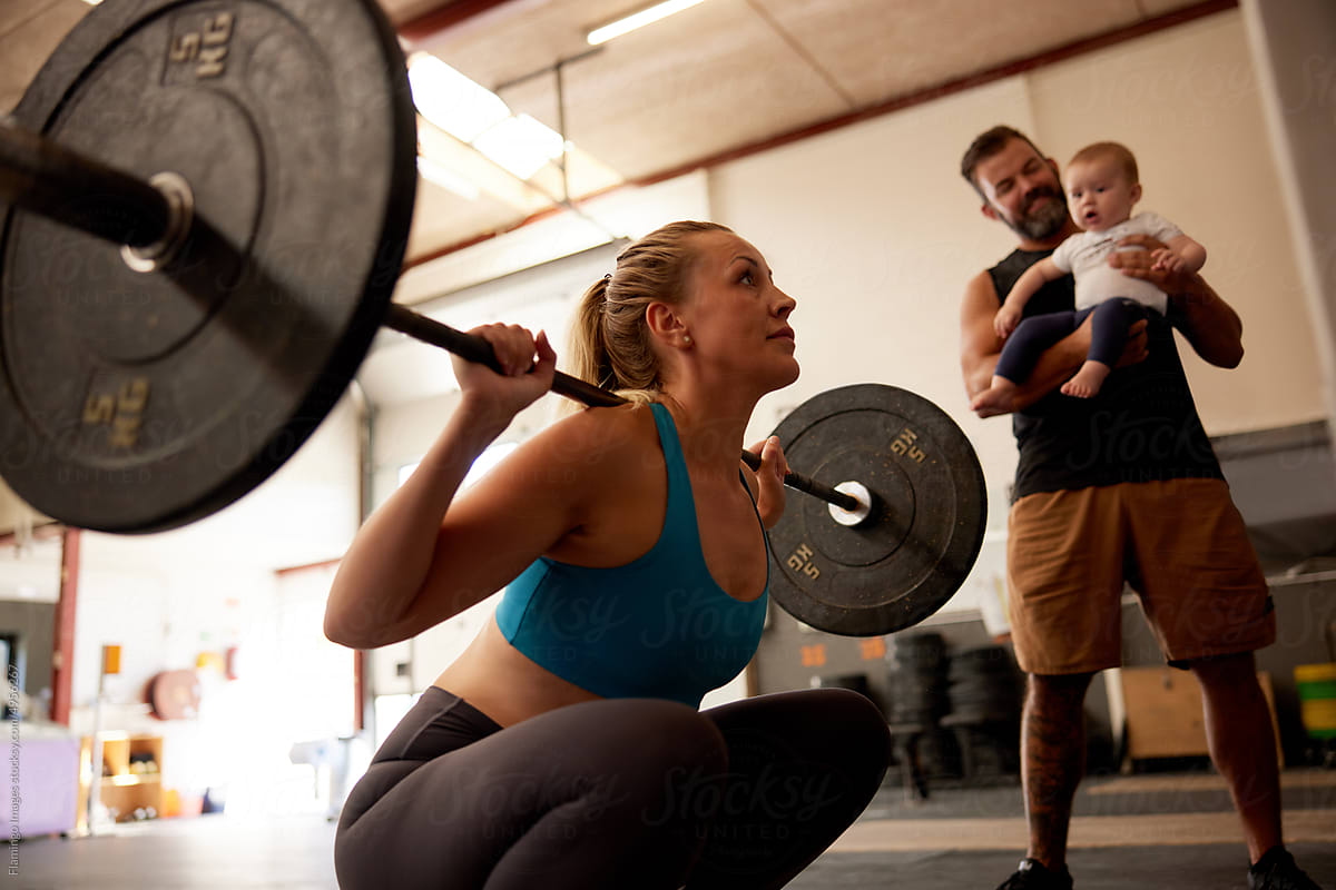 Woman weightlifting with her family