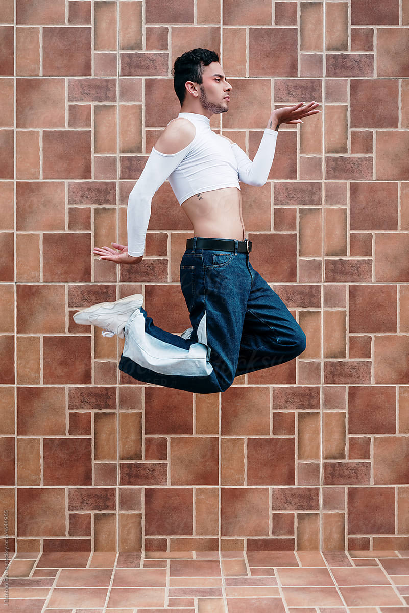Queer suspended in mid-air performing a dance pose