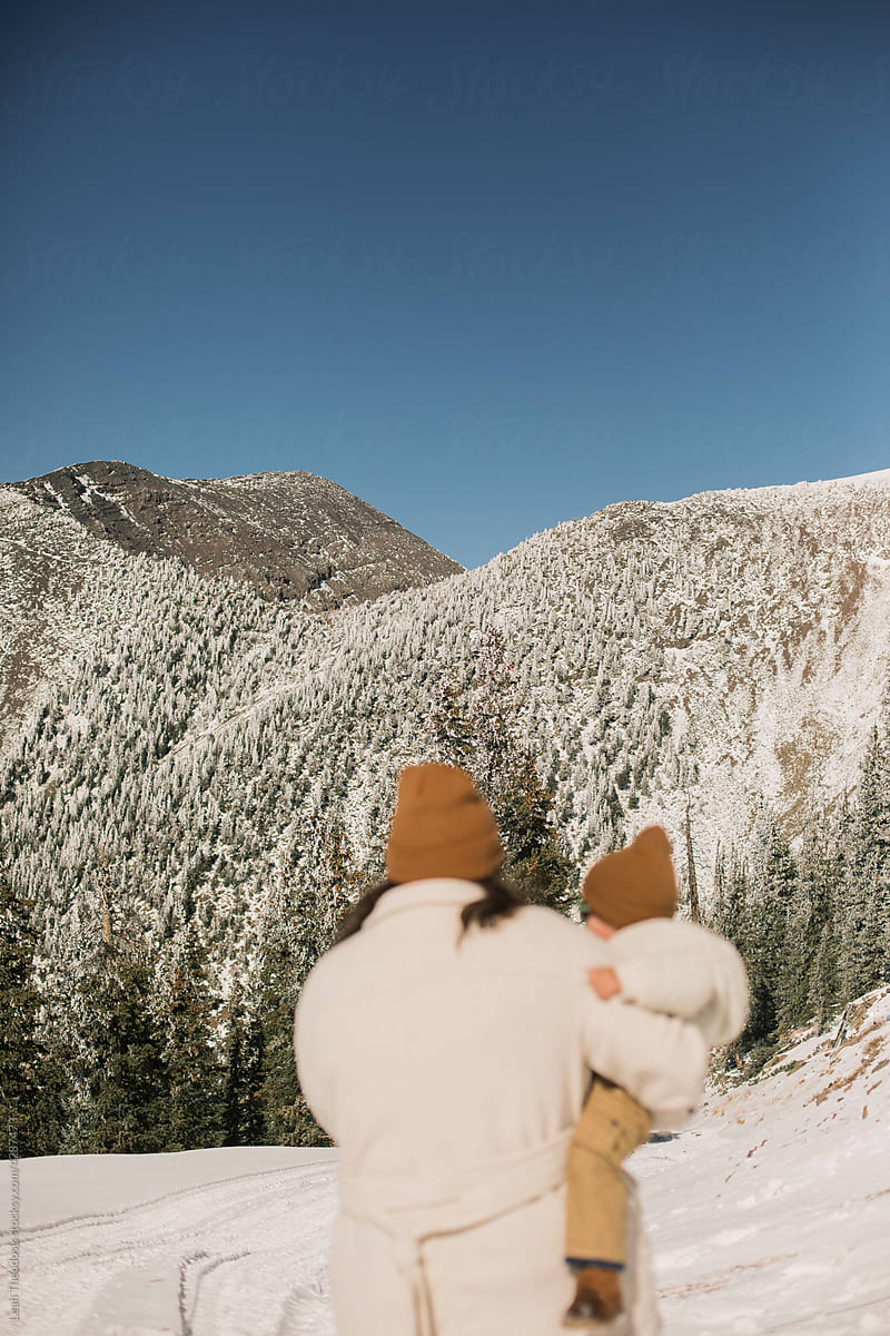 Mother and Toddler Looking at Snow Covered Mountain
