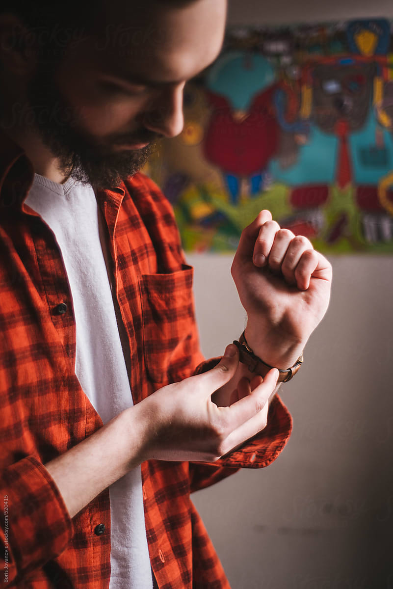 Bearded man setting up his watch