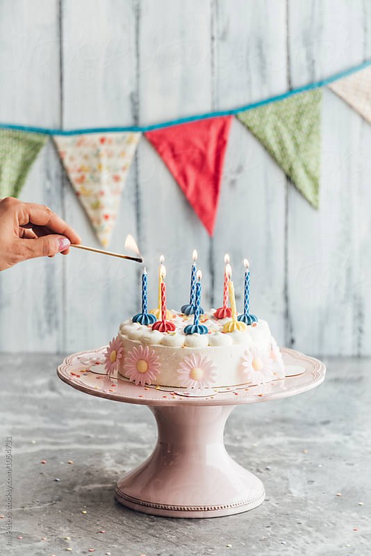 Food: Candles on birthday cake is being lighted