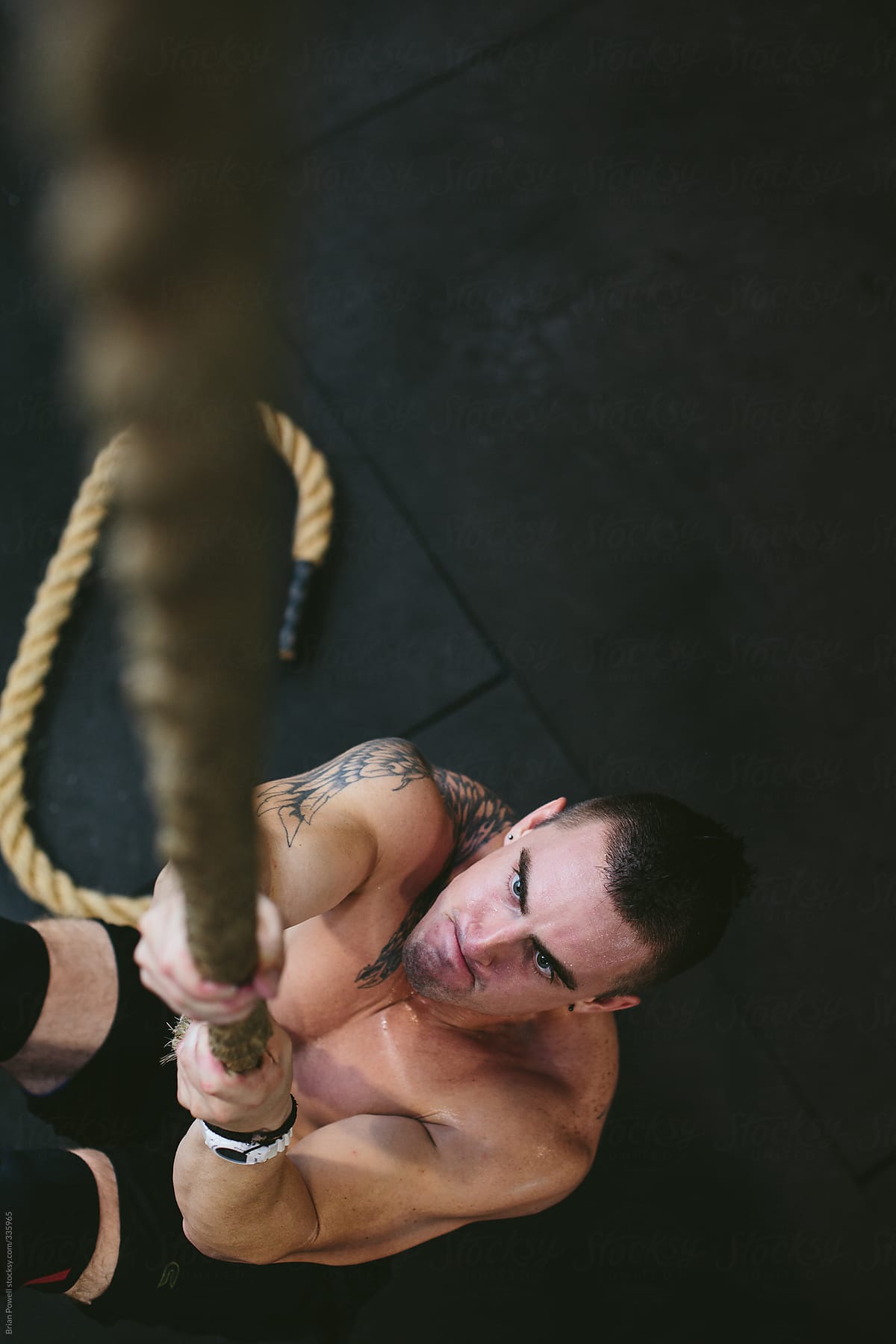 Man Doing L Sit Rope Climb In Gym By Stocksy Contributor Brian