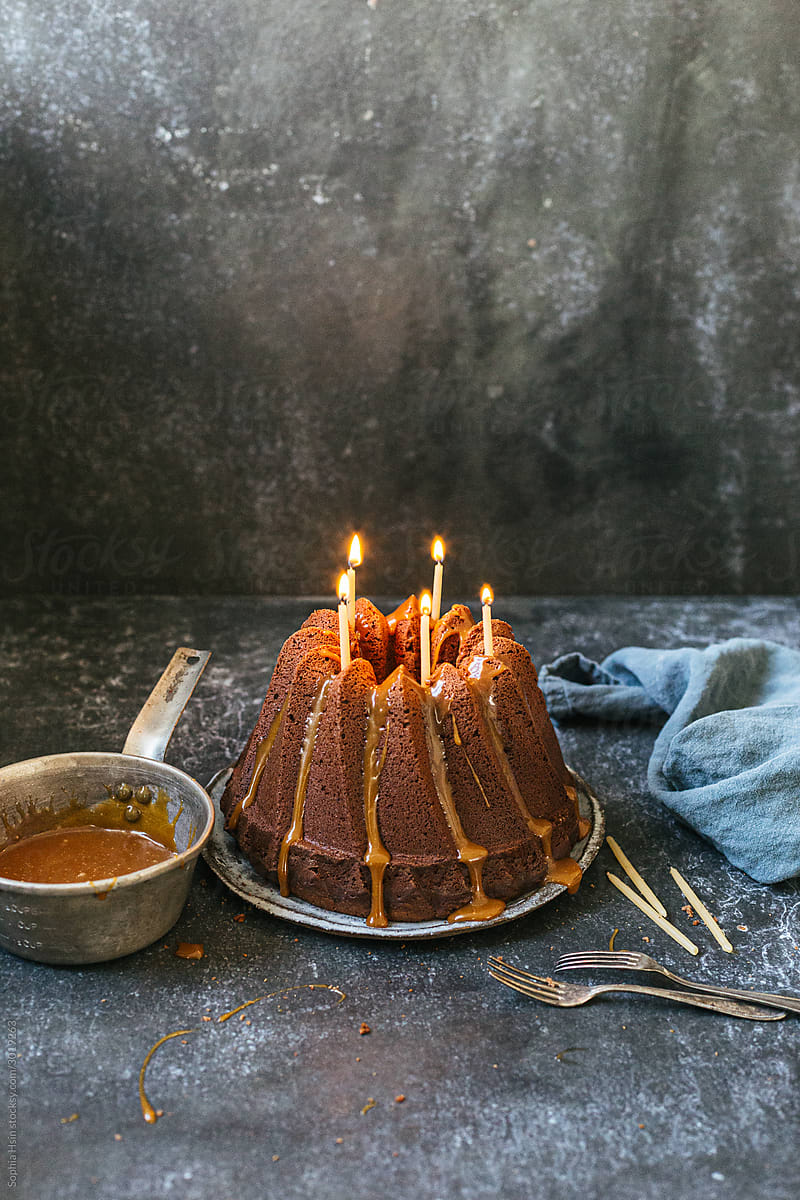 bundt cake with caramel sauce with candles