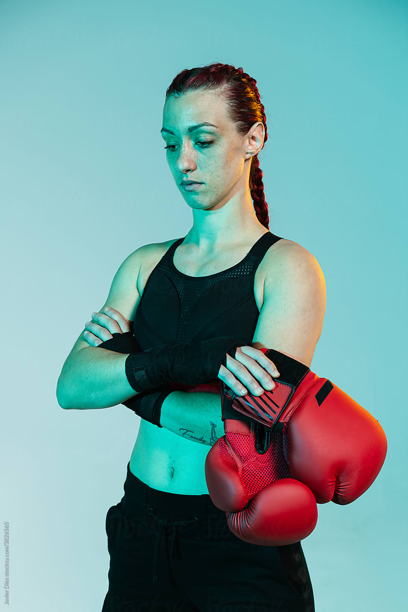 Confident sportswoman with boxer gloves