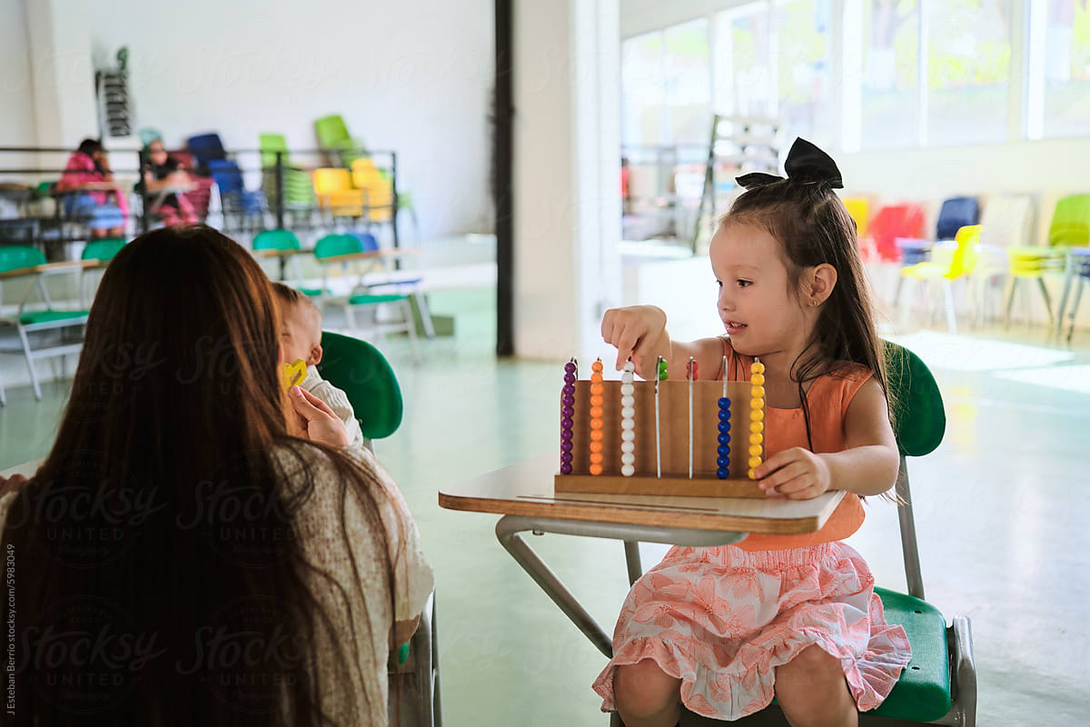 Latina girl using an abacus in the classroom