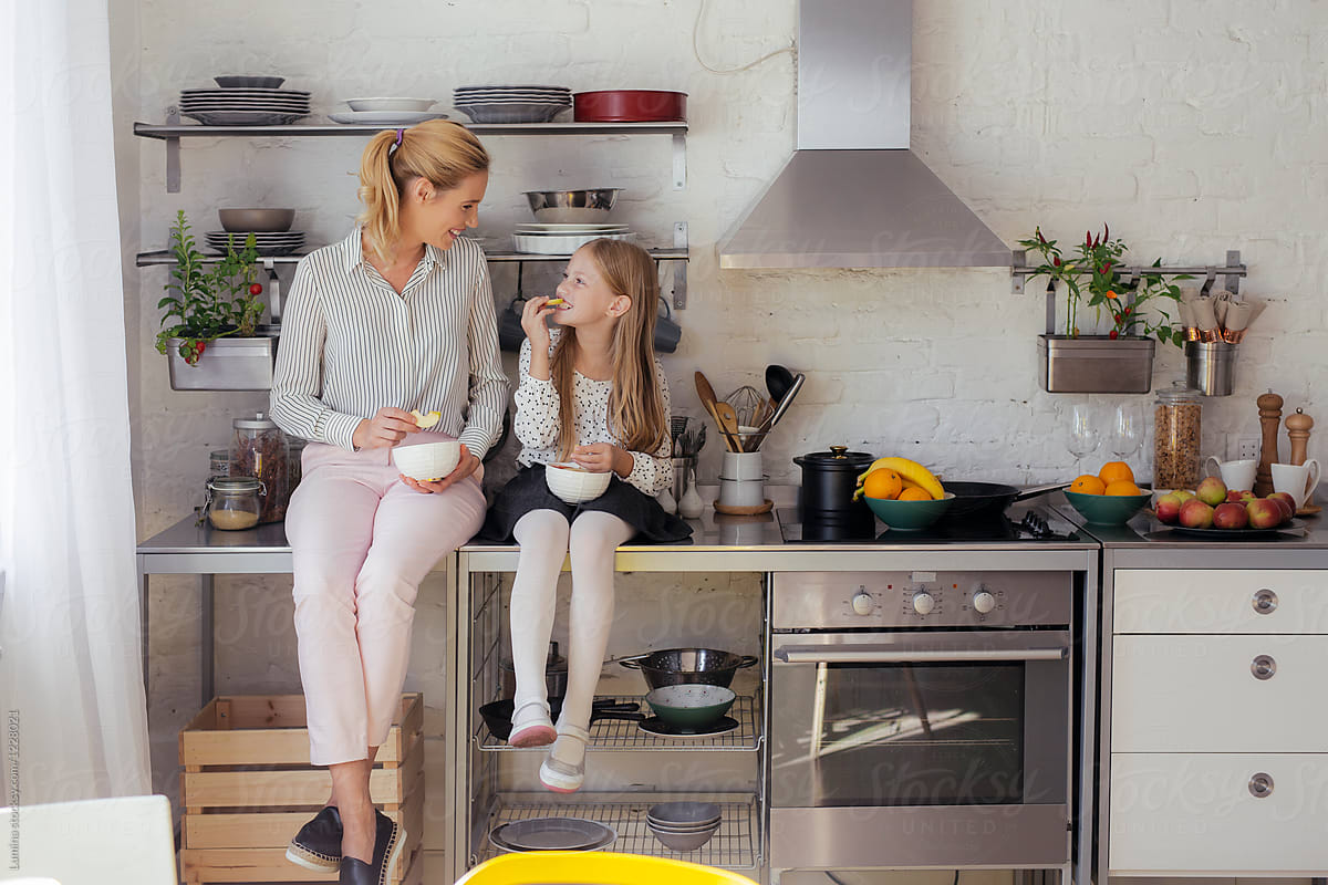 Mother And Daughter Eating Together In The Kitchen By Stocksy Contributor Lumina Stocksy 