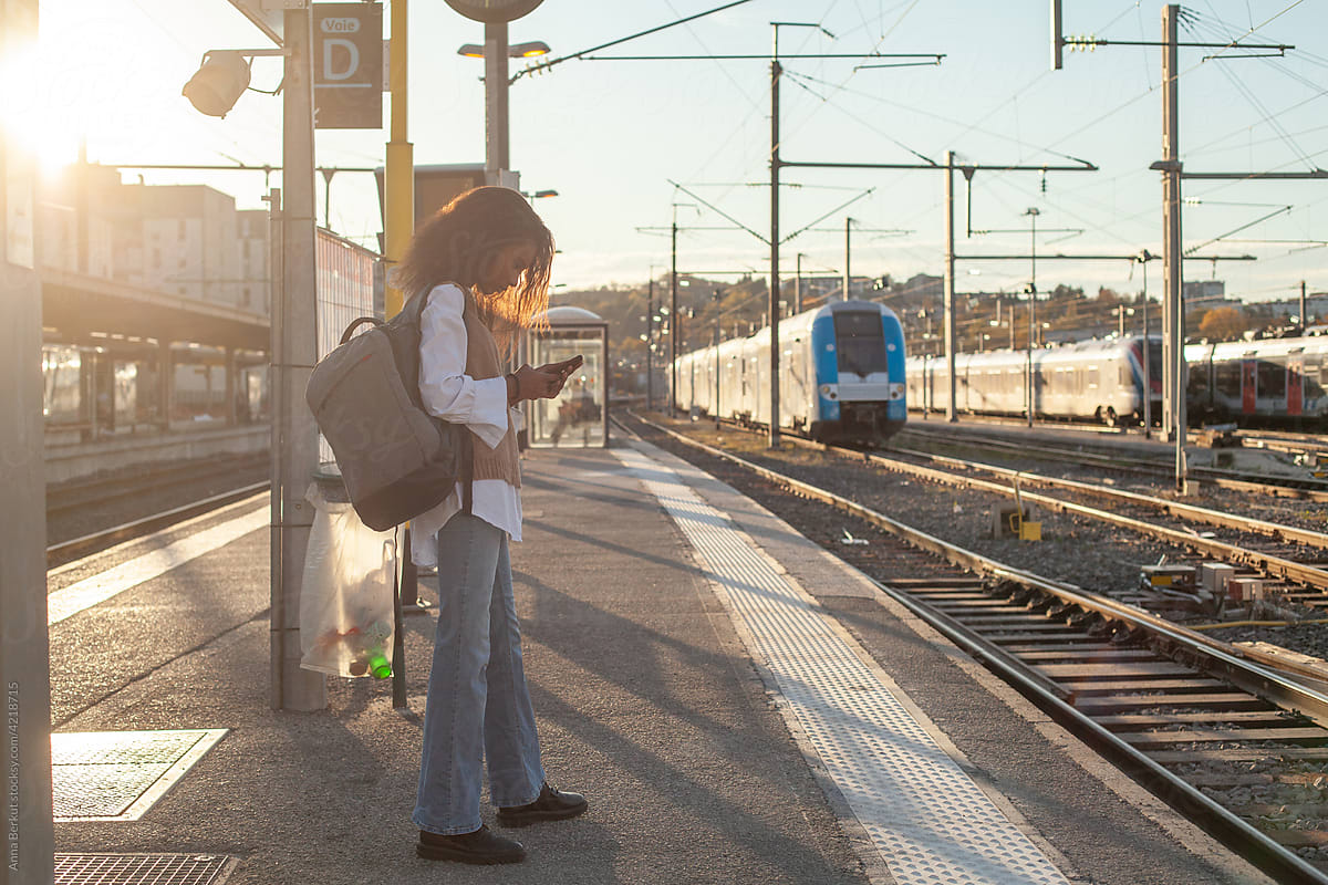 travel by train, black woman passenger waiting on railway station