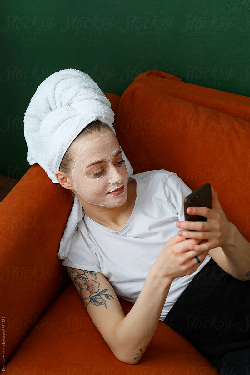 Positive female with cosmetic mask using smartphone