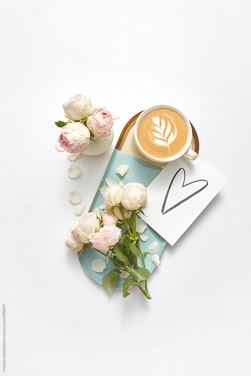 Drawn heart on a card with coffee and flowers.