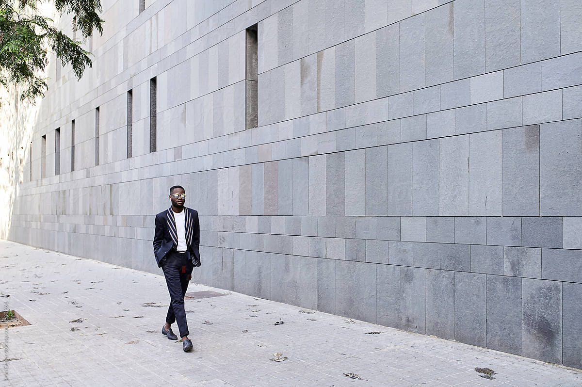 Stylish black afro businessman walk to work.