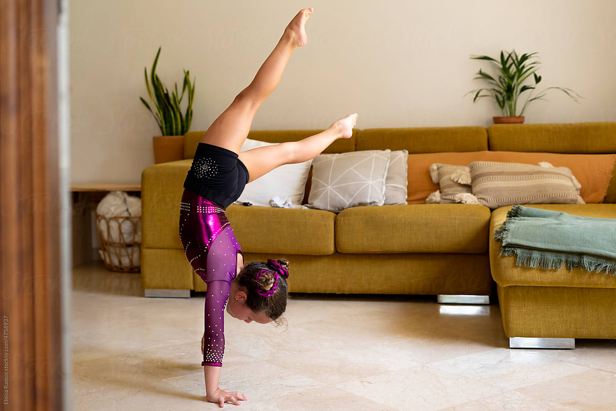 little girl practicing artistic gymnastics at home