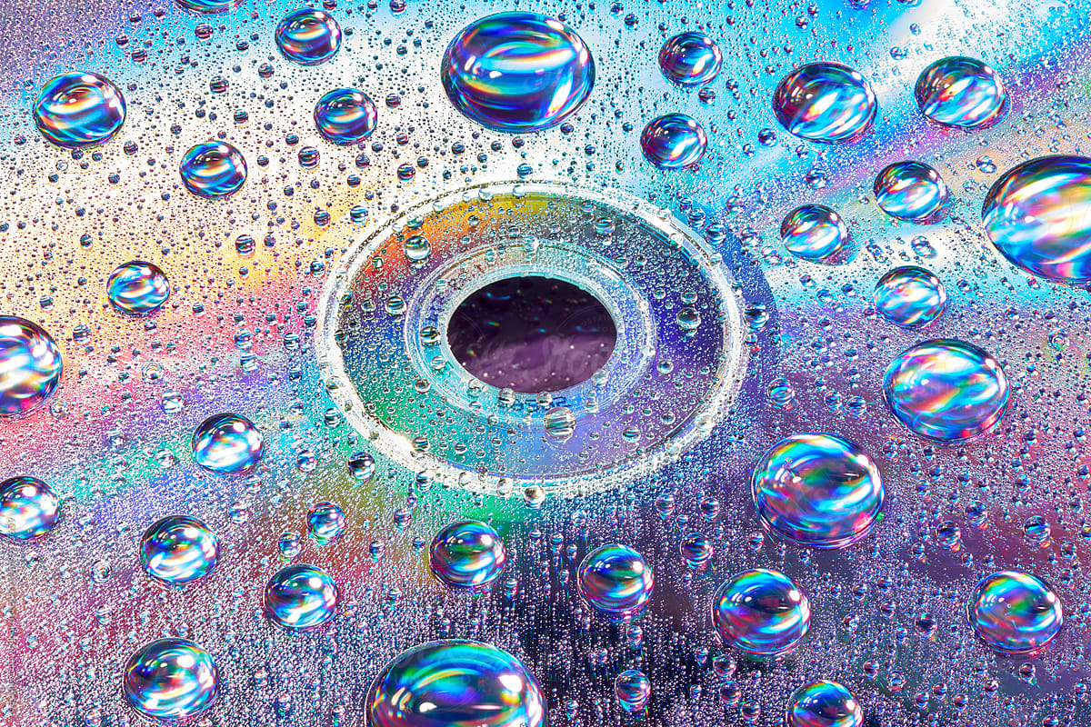 Compact CD disc with iridescent light and water droplets