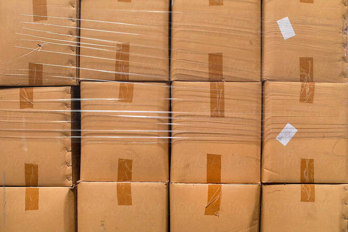 A stock photo close up of cardboard packages wrapped in the protective foil