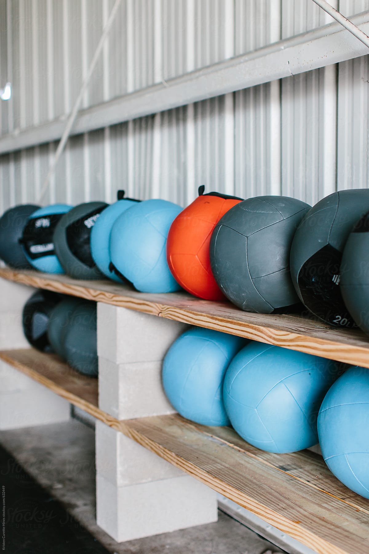 Heavy medicine balls lined up in an indoor gym