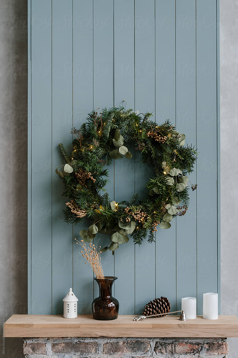 Christmas wreath over mantelpiece with decorations