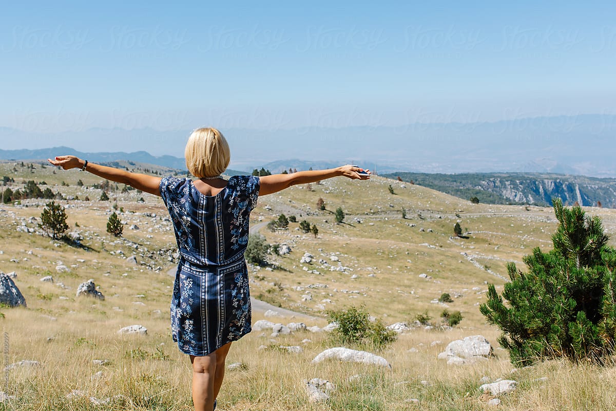 Woman enjoying in the nature with arms wide open