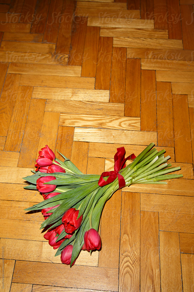 Bouquet of red tulips on floor