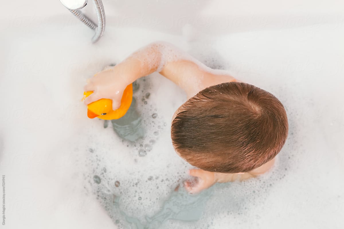 Toddler with Rubber Duck Toy in the Bathtub, Top View