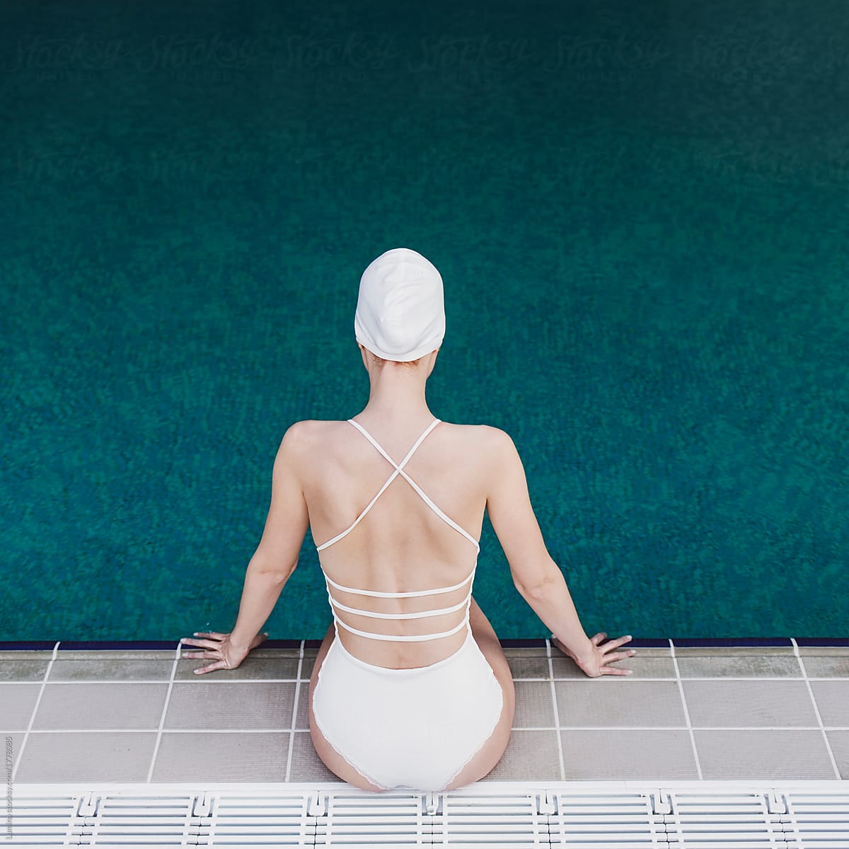 Woman Sitting by the Swimming Pool