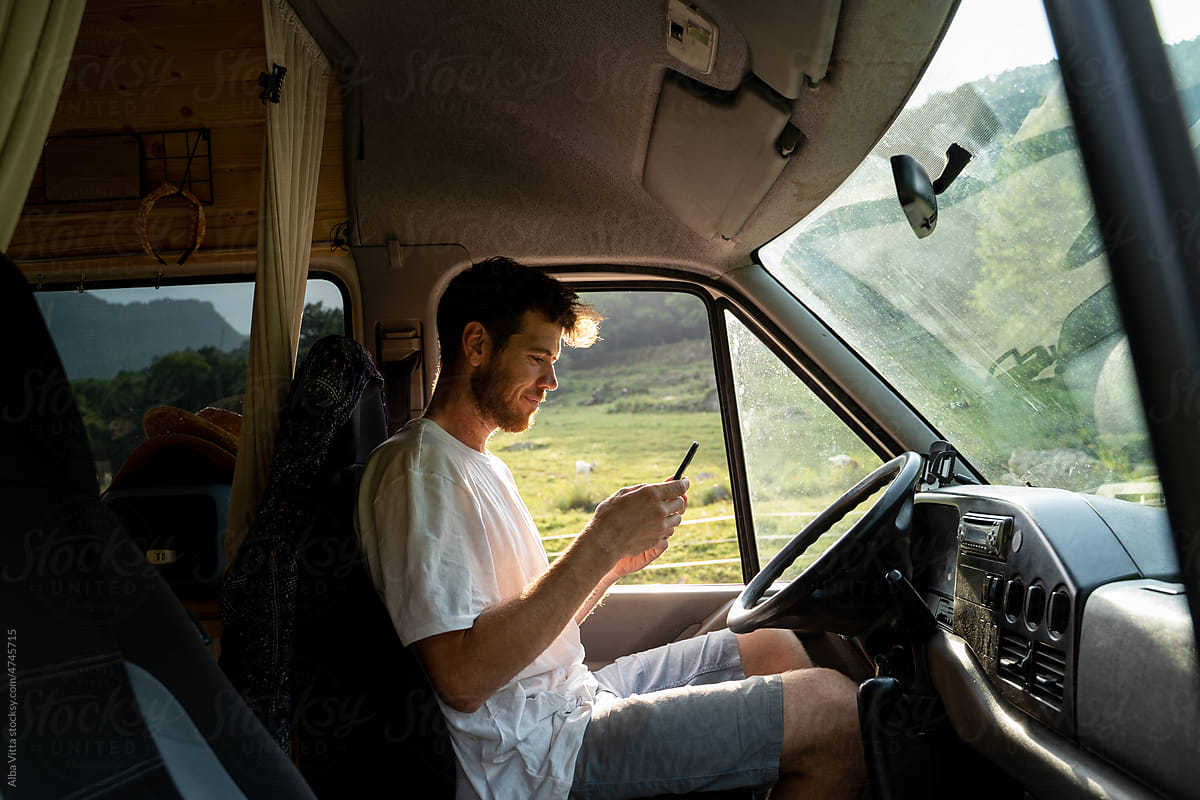 Man using phone inside camper van