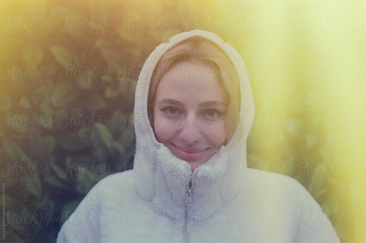 Lo-fi portrait of a girl wearing white hoodie. Photo with light leaks