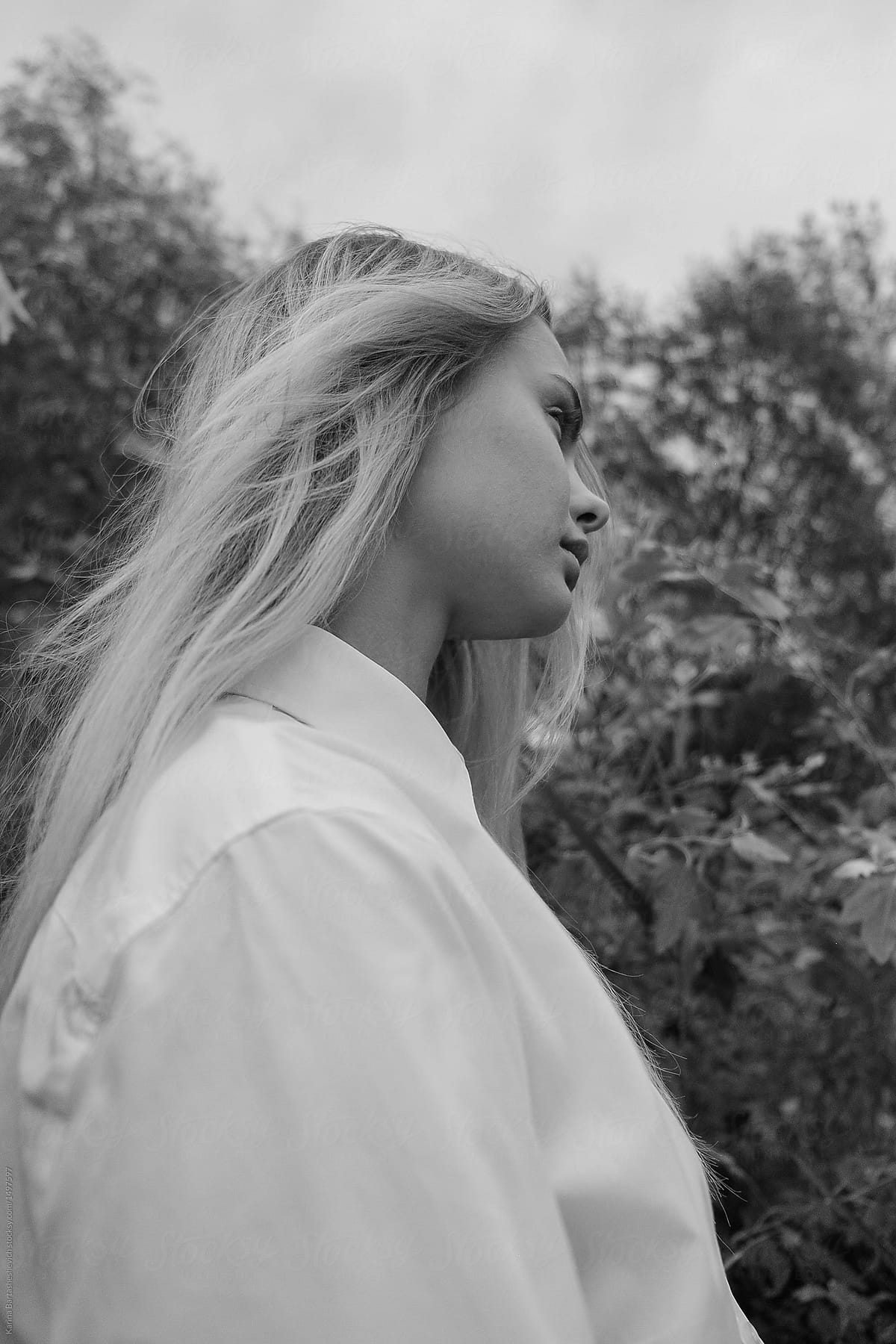 Black And White Portrait Of Beautiful Blonde Girl In White Shirt Near