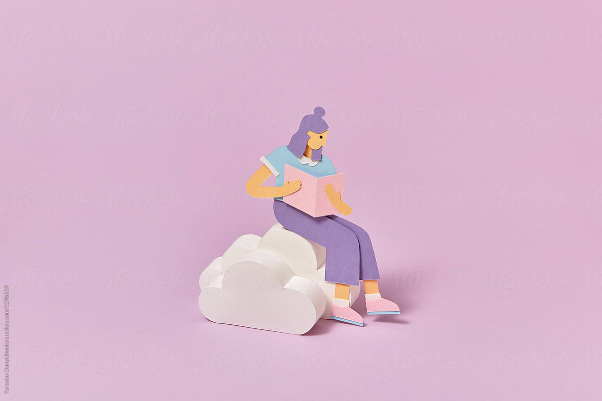 Papercraft schoolgirl is reading book on a clouds.