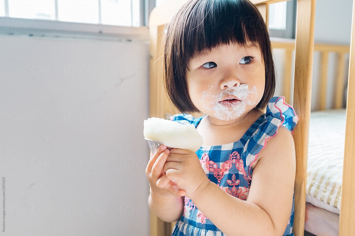 little girl eating cake