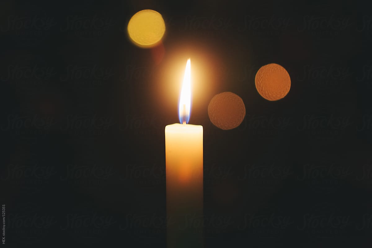 "Single Candle Flame, Black Background" by Stocksy Contributor "Mattia