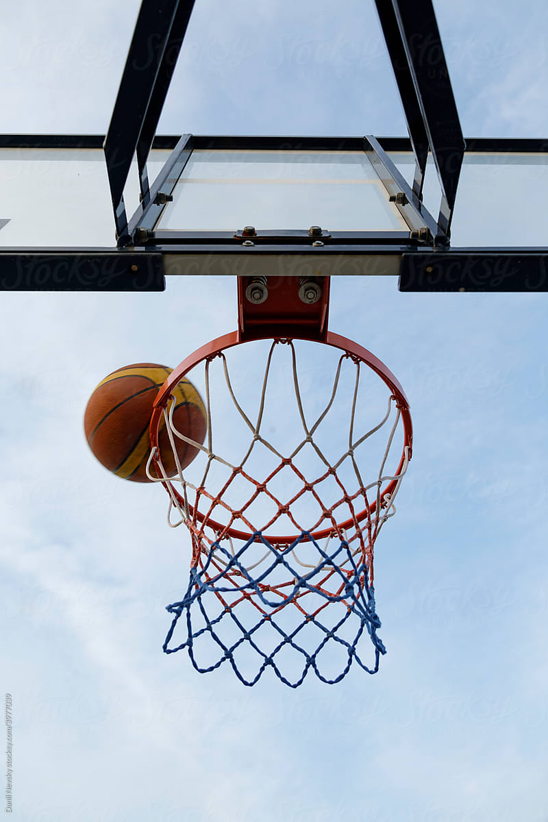 Basketball ball falling into hoop