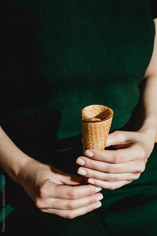 Woman is holding ice cream cone