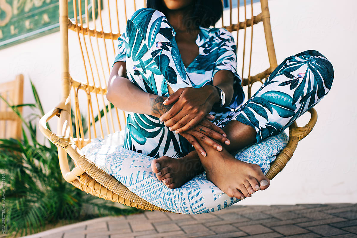 Closeup of Anonymous Young Fashionable Black Woman Sitting in Hanging Wicker Chair