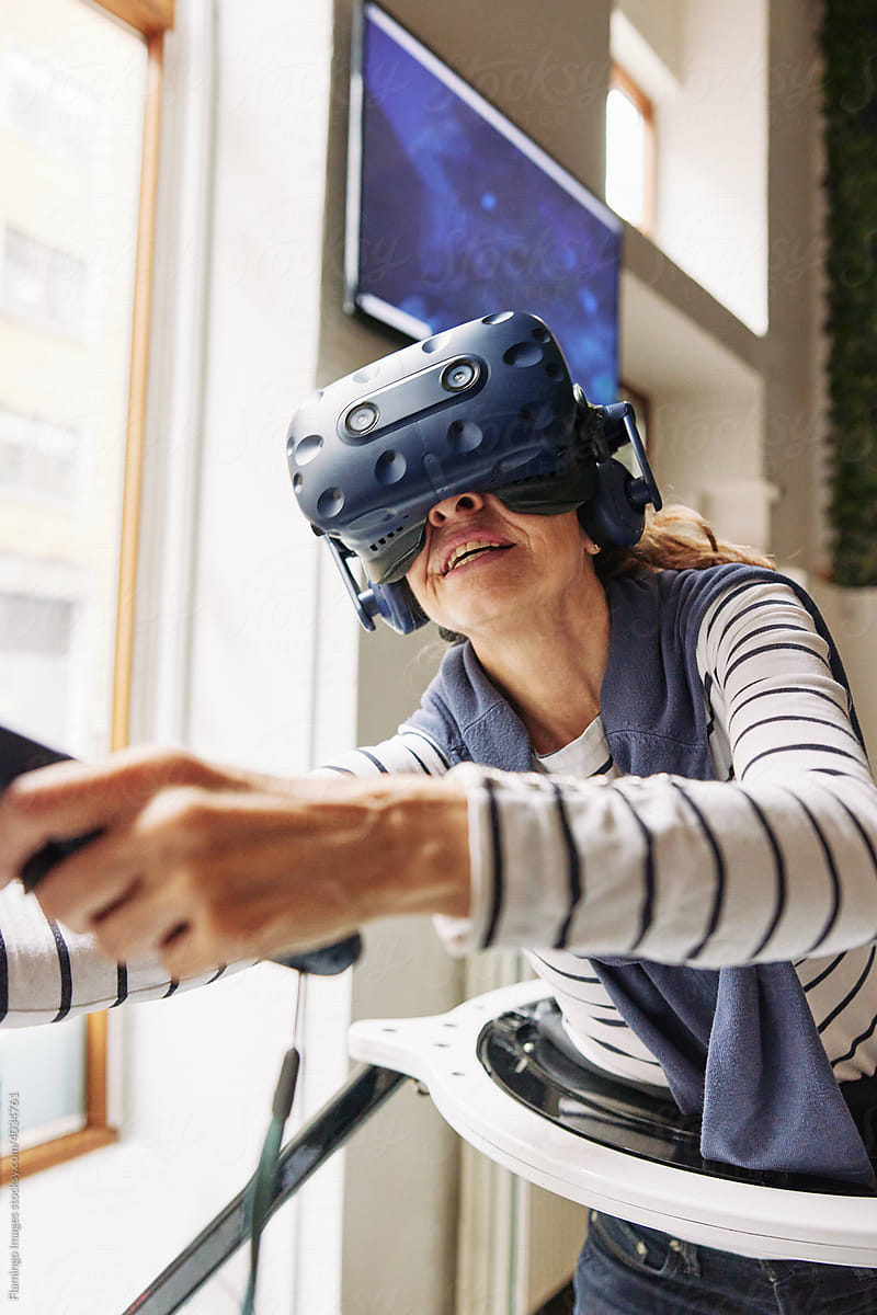 Senior woman using vr controllers and a headset