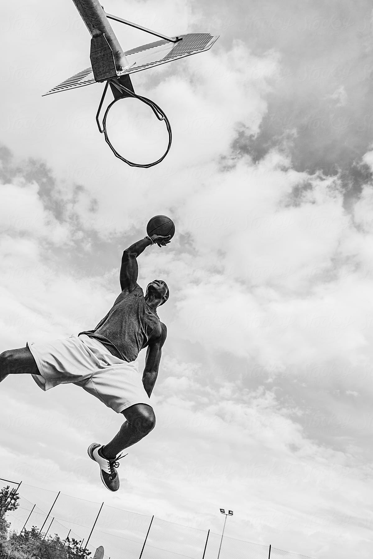 Young Black Man Playing in a Street Basketball Court