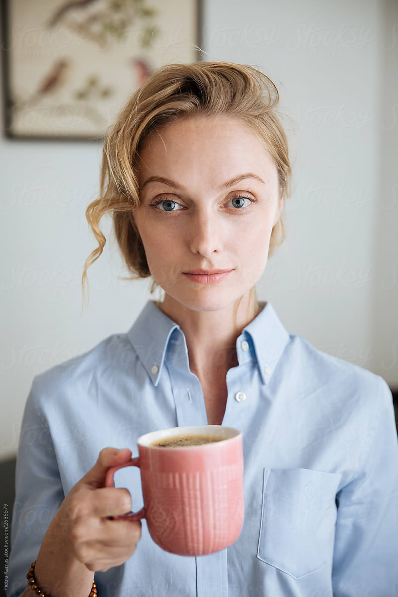 Beautiful charming woman with big cup of coffee