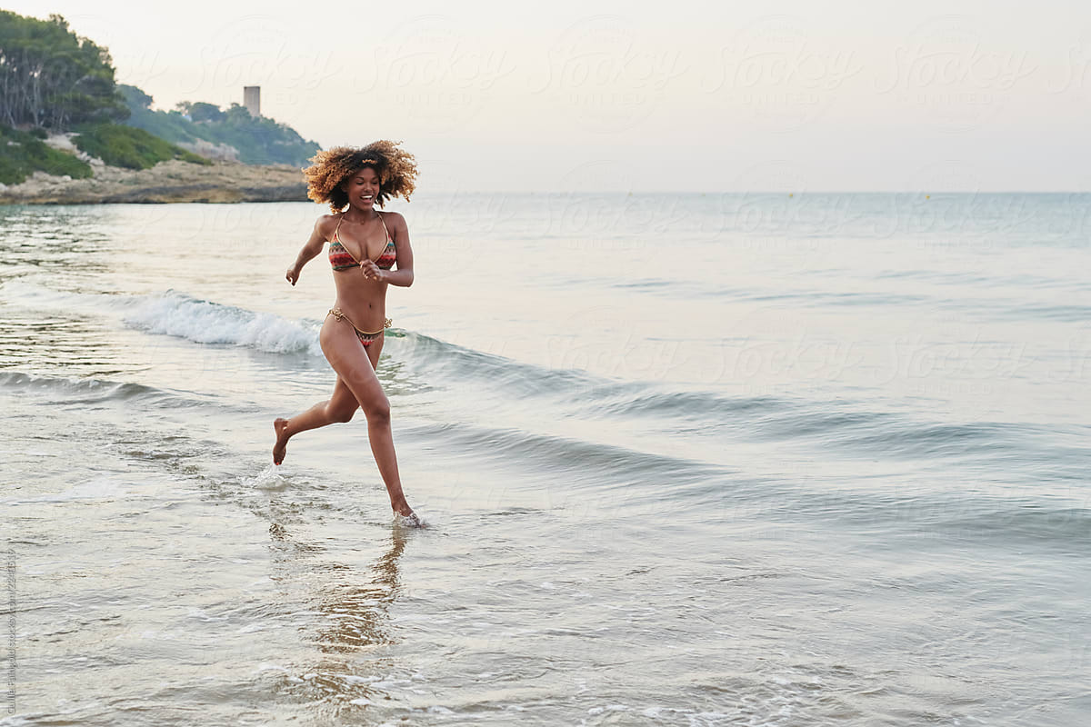 Black women in bikinis at beach Laughing Black Woman In Bikini Running On Beach By Guille Faingold Beach Running