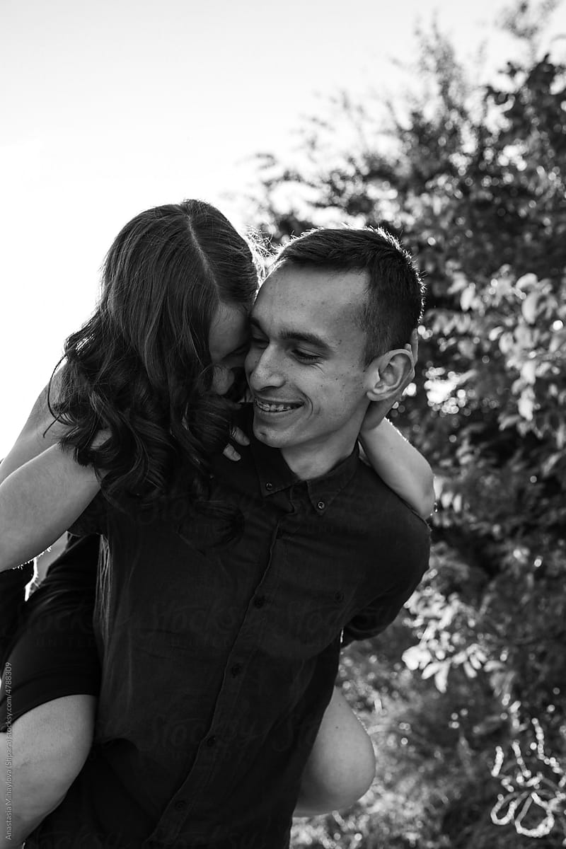 Black and white photo of a Man is spinning with his woman in his arms