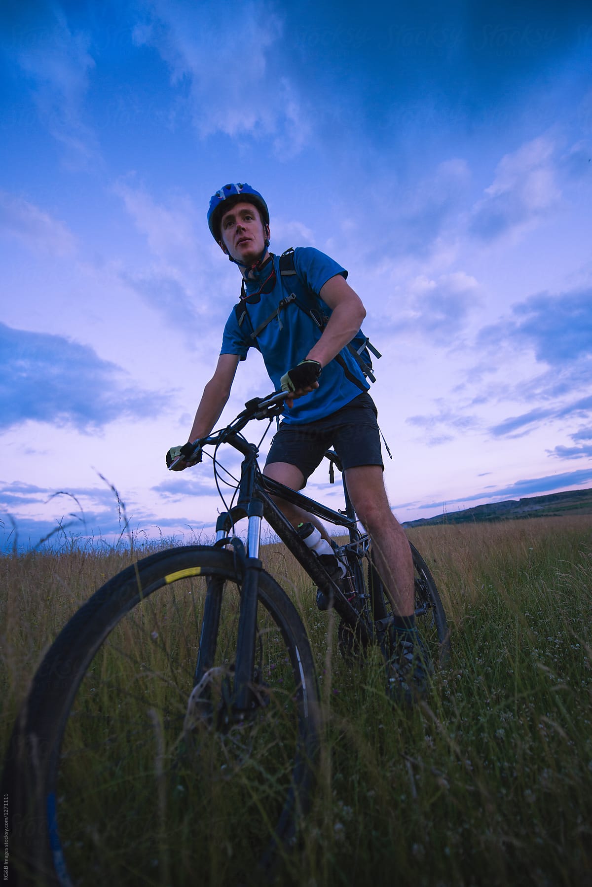Male Athlete Riding Mountain Bike Off Road On A Green Field By Stocksy Contributor Ibex Media