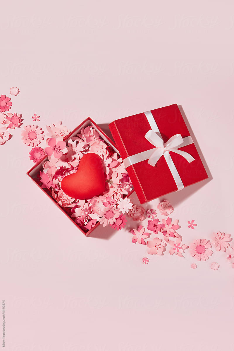 Heart in open red gift box full of pink paper art flowers