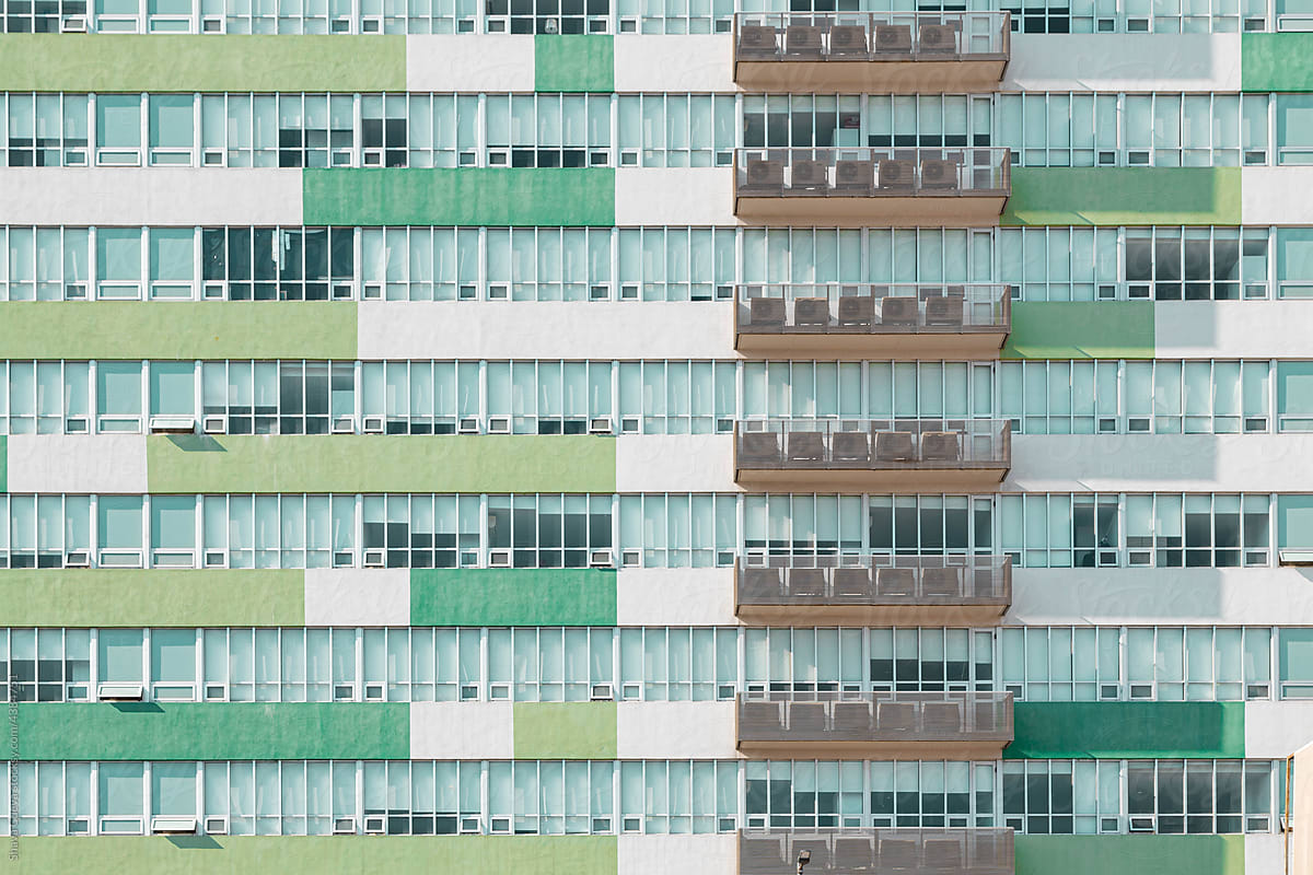 green building with balconies on the right side
