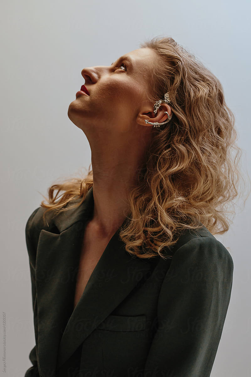Profile studio portrait blonde woman with wavy hair