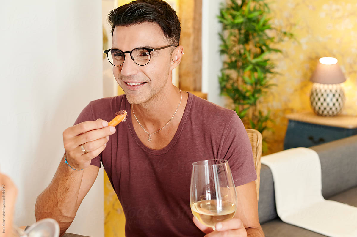 Gay couple talking over wine with dinner