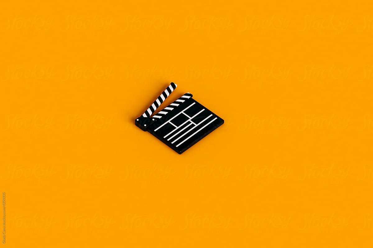 clapperboard isolated on orange background