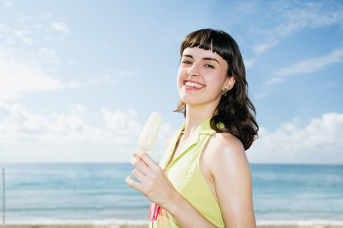 Smiling woman with popsicle