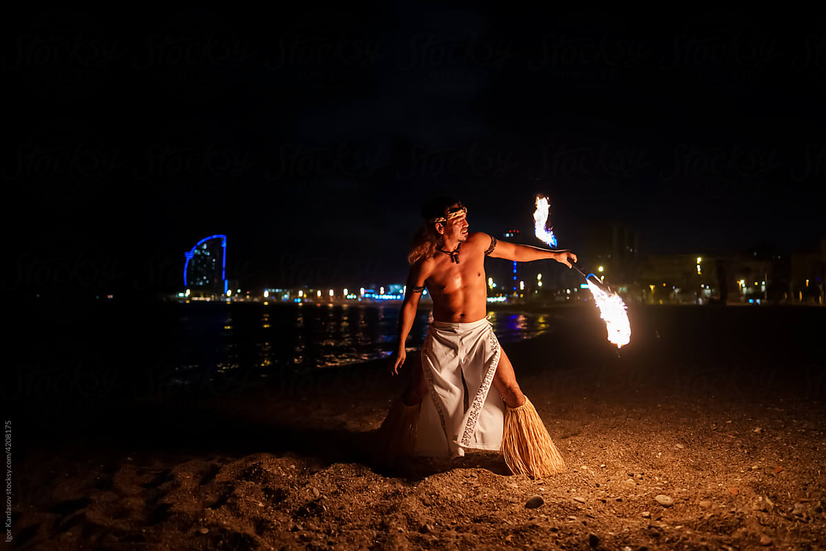 Man doing fire show on the beach